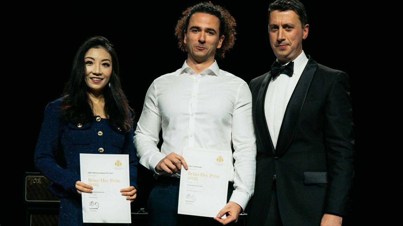 Prize winners Patricia Wang and Karol Gawlowski, with IFoA GIRO Conference 2025 chair Matthew Facey